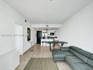 888 Biscayne Boulevard, #811, Miami, FL 33132 Open-concept living area featuring tile flooring, white walls, and recessed lighting