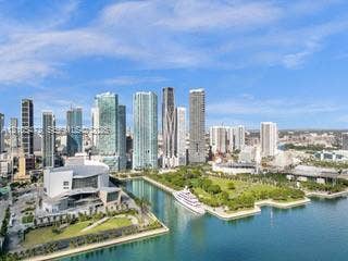 888 Biscayne Boulevard, #811, Miami, FL 33132 Downtown cityscape featuring numerous high-rise buildings, waterfront access, a large public park, and a prominent performance venue