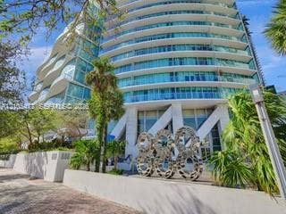 888 Biscayne Boulevard, #811, Miami, FL 33132 Modern high-rise building with curved glass balconies and a unique architectural facade