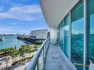 888 Biscayne Boulevard, #811, Miami, FL 33132 Expansive outdoor balcony with glass railing, providing water and city skyline elements