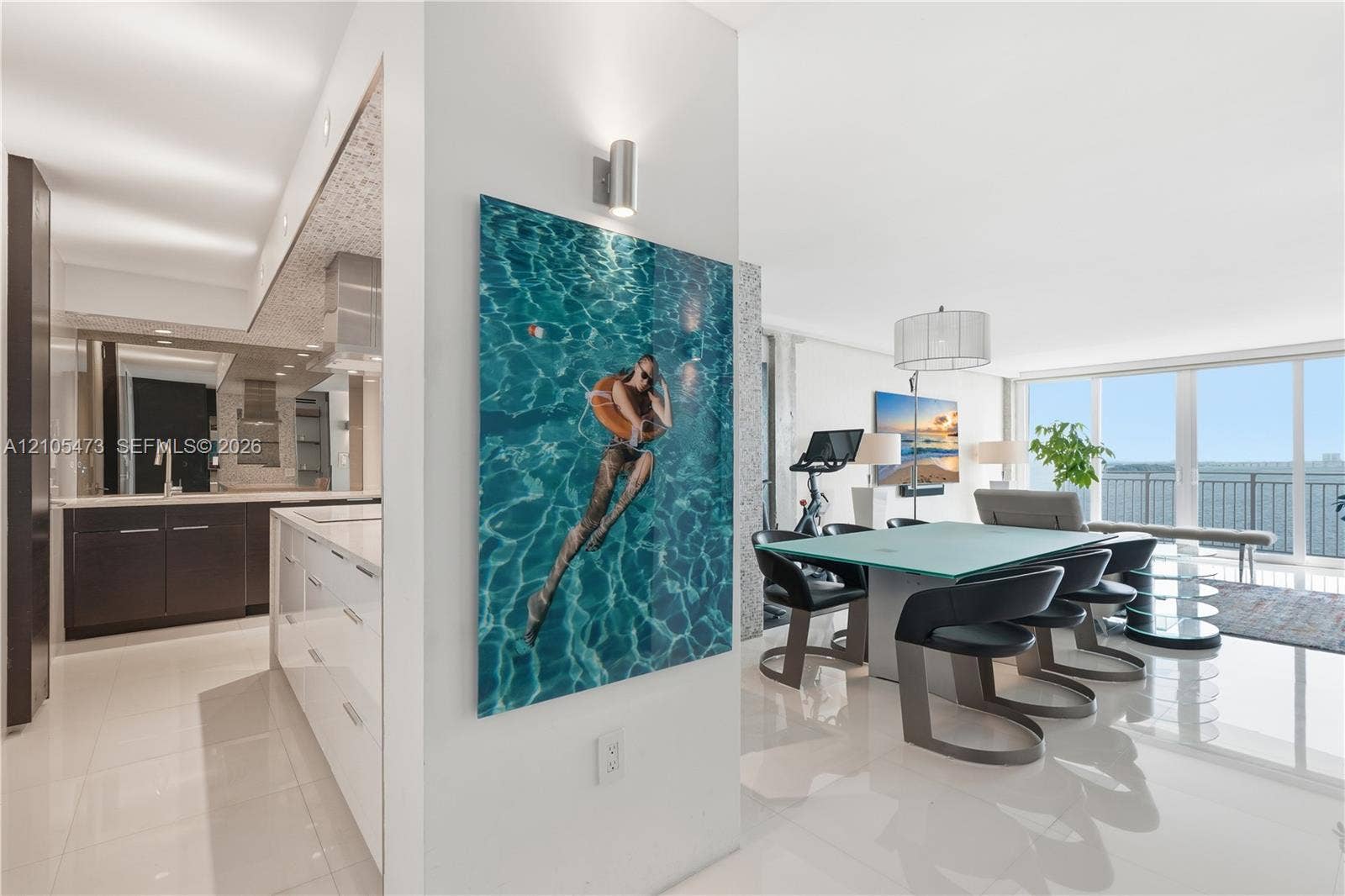 770 NE 69th Street, #6F, Miami, FL 33138 Gourmet kitchen with dark wood-finish cabinetry, a large central island with integrated storage, and a light-toned backsplash