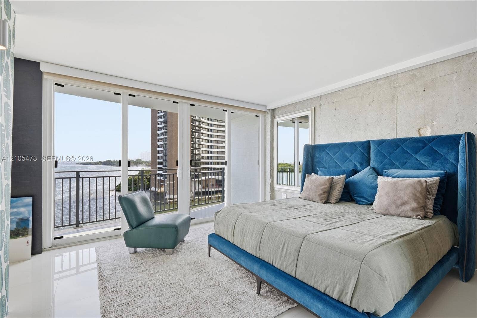 770 NE 69th Street, #6F, Miami, FL 33138 Floor-to-ceiling sliding glass doors open to a balcony with black railings