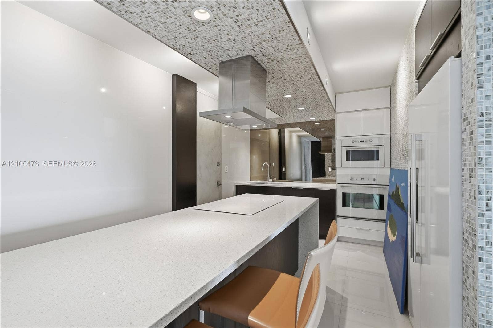 770 NE 69th Street, #6F, Miami, FL 33138 Kitchen featuring a built-in cooktop, stainless steel range hood, integrated wall oven and microwave, and white built-in refrigerator