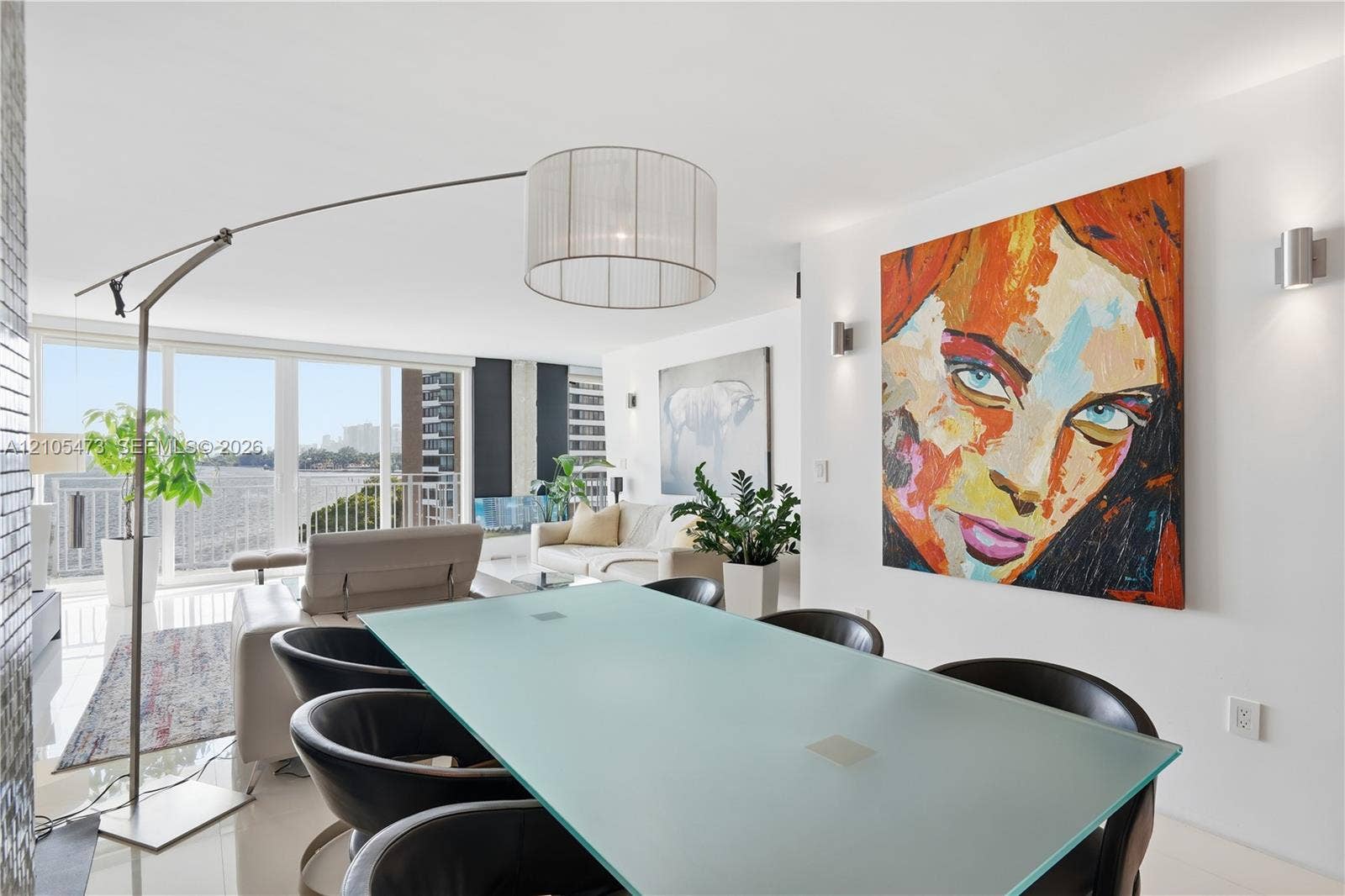 770 NE 69th Street, #6F, Miami, FL 33138 Floor-to-ceiling glass doors, white tile flooring, and recessed wall lighting