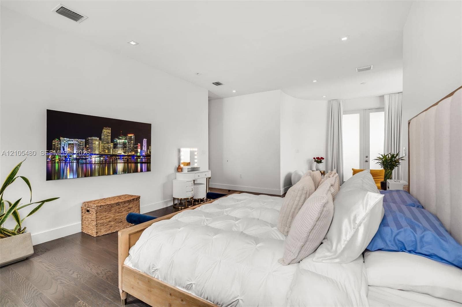 Recessed lighting, wood-finish flooring, white walls, and French doors with privacy curtains
