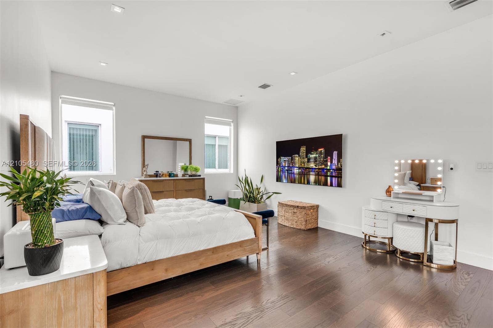 Recessed lighting, wood-finish flooring, two windows, and white walls