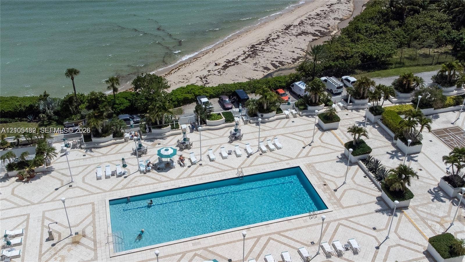 2100 S Ocean Lane, #808, Fort Lauderdale, FL 33316 Rectangular swimming pool featuring decorative paved decking, integrated landscaping, and perimeter lighting