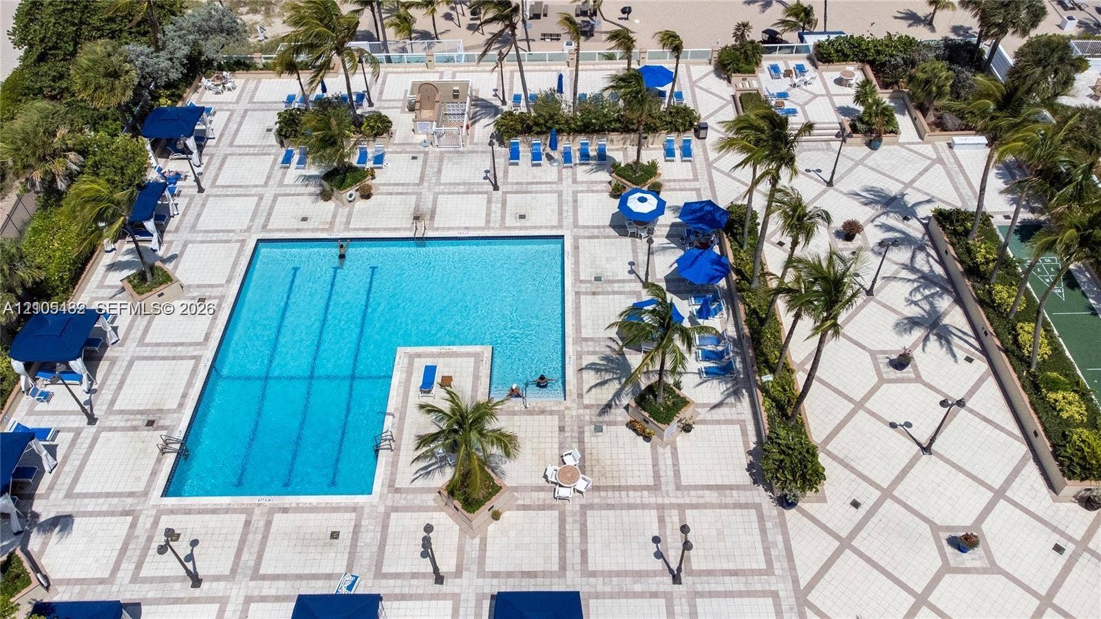2100 S Ocean Lane, #808, Fort Lauderdale, FL 33316 Swimming pool with multi-lane configuration, expansive stone-paver sun deck, integrated tropical landscaping, and surrounding pedestrian pathways