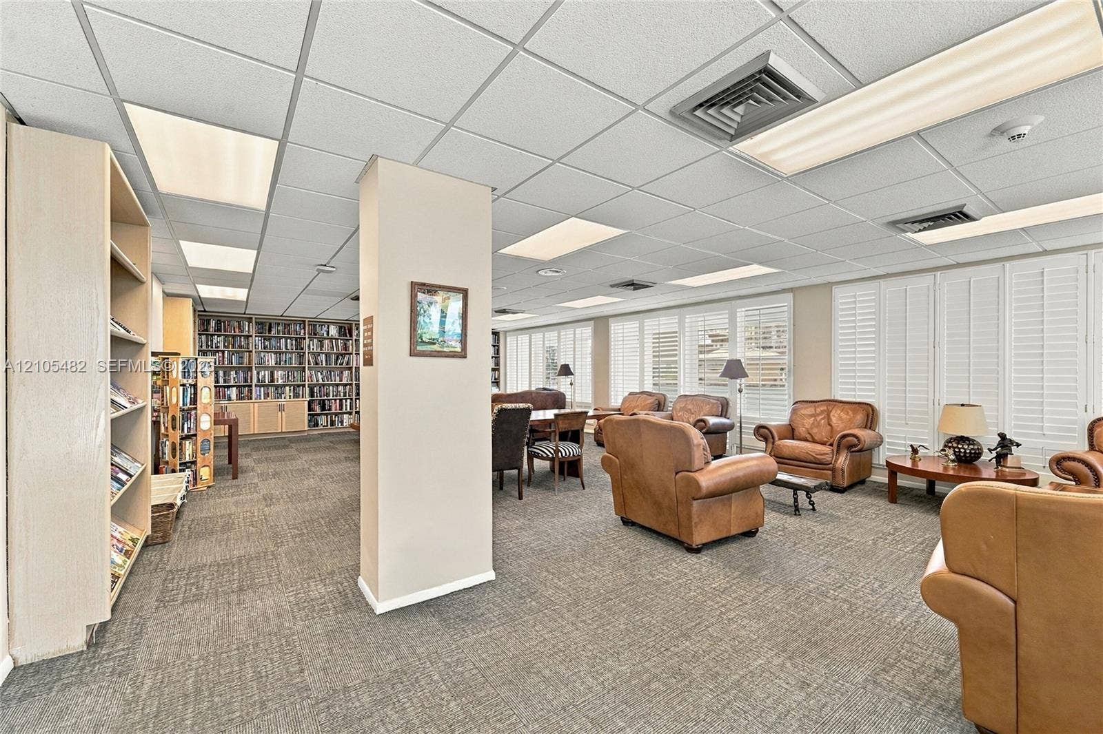 2100 S Ocean Lane, #808, Fort Lauderdale, FL 33316 Built-in floor-to-ceiling shelving, neutral carpet flooring, drop ceiling with integrated lighting, and plantation shutters