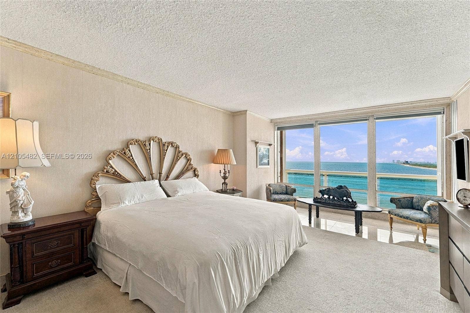 2100 S Ocean Lane, #808, Fort Lauderdale, FL 33316 Floor-to-ceiling windows featuring ocean scenery, carpeted flooring, and wall-mounted crown molding