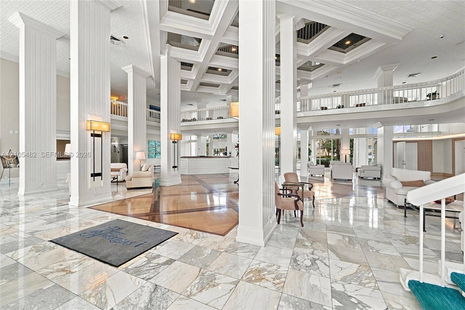 2100 S Ocean Lane, #808, Fort Lauderdale, FL 33316 Grand atrium featuring coffered ceilings, polished stone flooring, structural columns with fluted detailing, and a mezzanine level with ornate railings