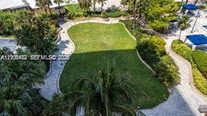 2100 S Ocean Lane, #808, Fort Lauderdale, FL 33316 Expansive central lawn featuring perimeter walkways, mature landscaping, and integrated outdoor recreational areas
