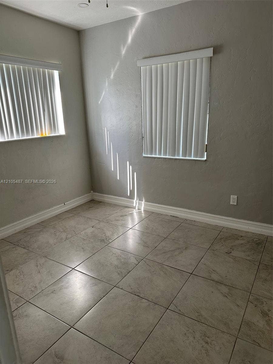 Neutral-toned walls complement the square-tiled flooring