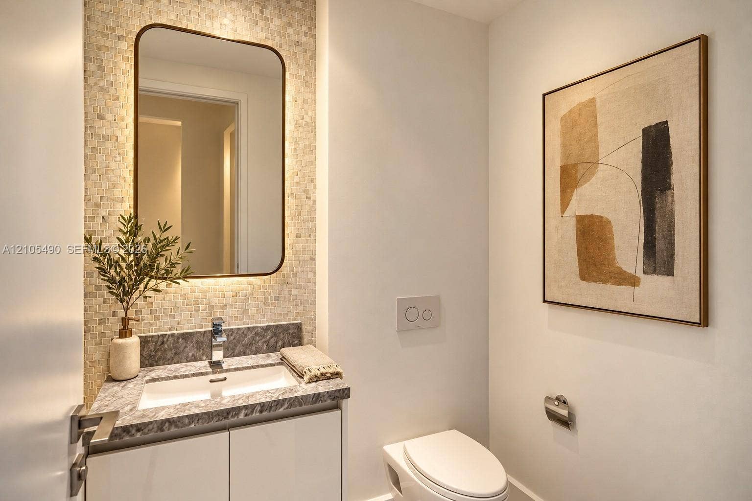 700 NE 26th Terrace, #3603, Miami, FL 33137 Floating vanity with a stone countertop, under-mount rectangular sink, mosaic tile backsplash, integrated mirror, and wall-mounted dual-flush toilet