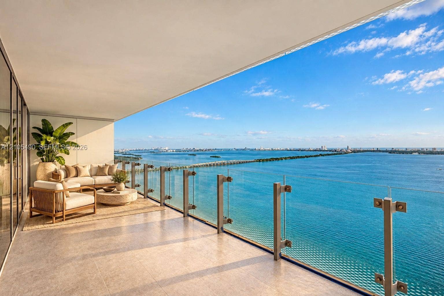 700 NE 26th Terrace, #3603, Miami, FL 33137 Expansive covered balcony featuring large-format stone tile flooring and a minimalist glass railing system with metal hardware