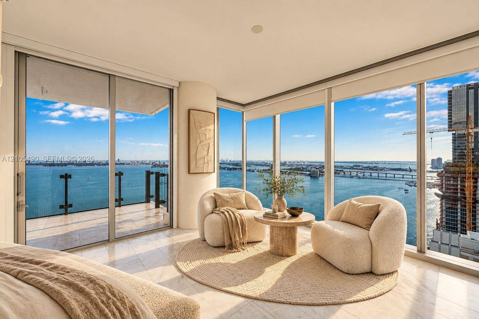 700 NE 26th Terrace, #3603, Miami, FL 33137 Floor-to-ceiling windows, wrap-around balcony with glass railing, stone-finish flooring, and expansive water scenery