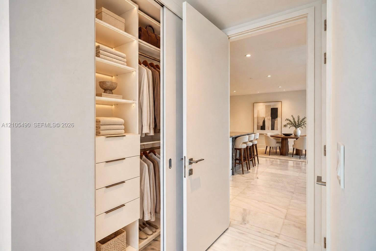 700 NE 26th Terrace, #3603, Miami, FL 33137 Custom built-in closet featuring integrated shelving, soft-close drawers with metallic pulls, and recessed lighting