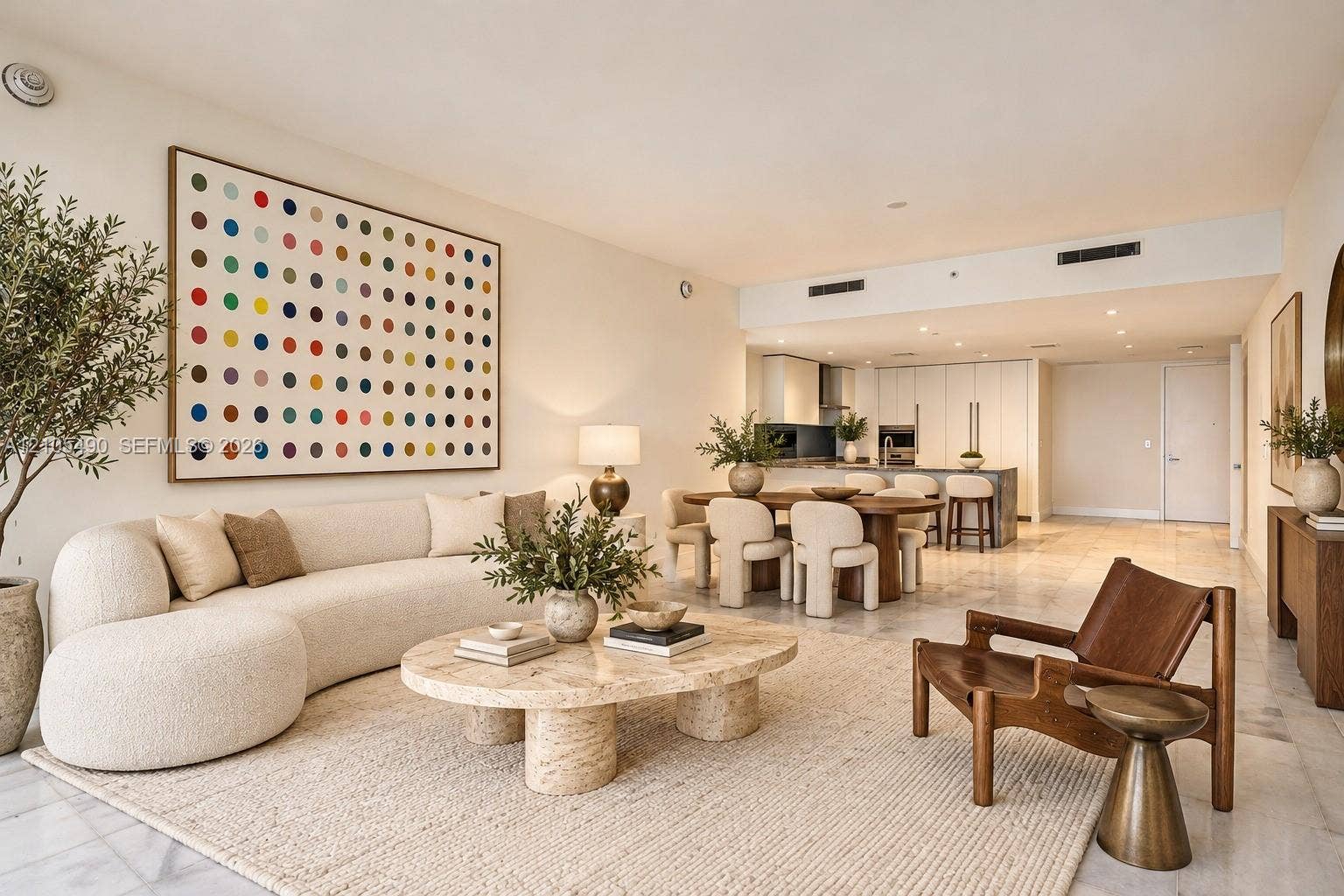 700 NE 26th Terrace, #3603, Miami, FL 33137 Open-concept interior featuring light-toned stone flooring, high ceilings with recessed lighting, and a modern kitchen with cabinetry and a center island