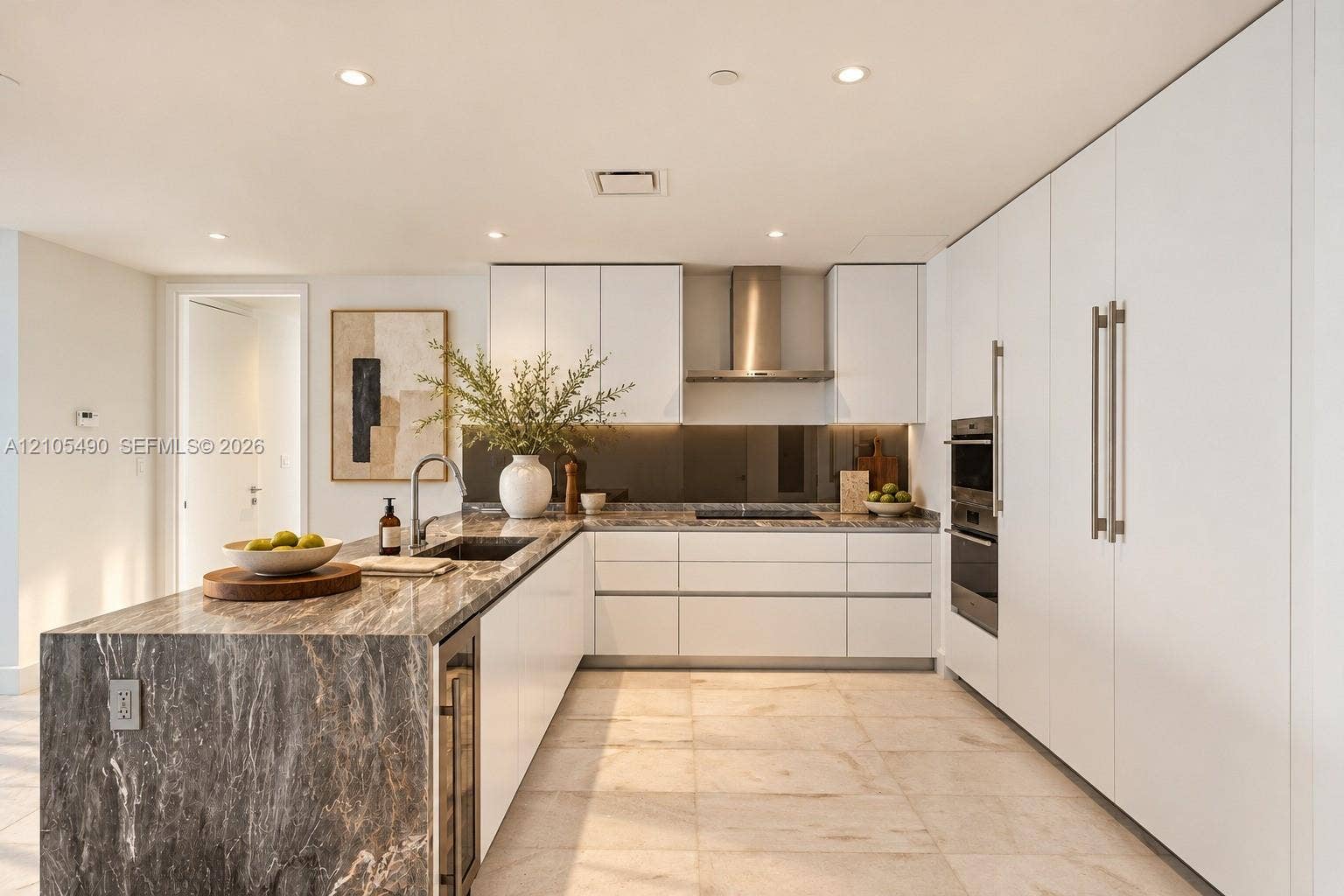 700 NE 26th Terrace, #3603, Miami, FL 33137 Kitchen featuring flat-panel white cabinetry, stone-patterned countertops, integrated stainless steel appliances, a stainless steel range hood, and tile flooring