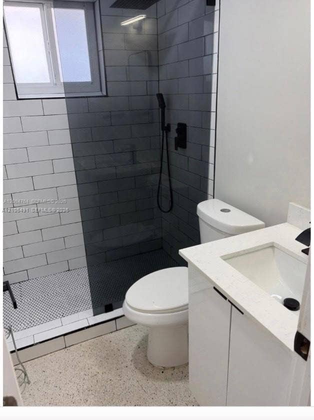 Shower with subway tile surround, matte black fixtures, and a glass enclosure