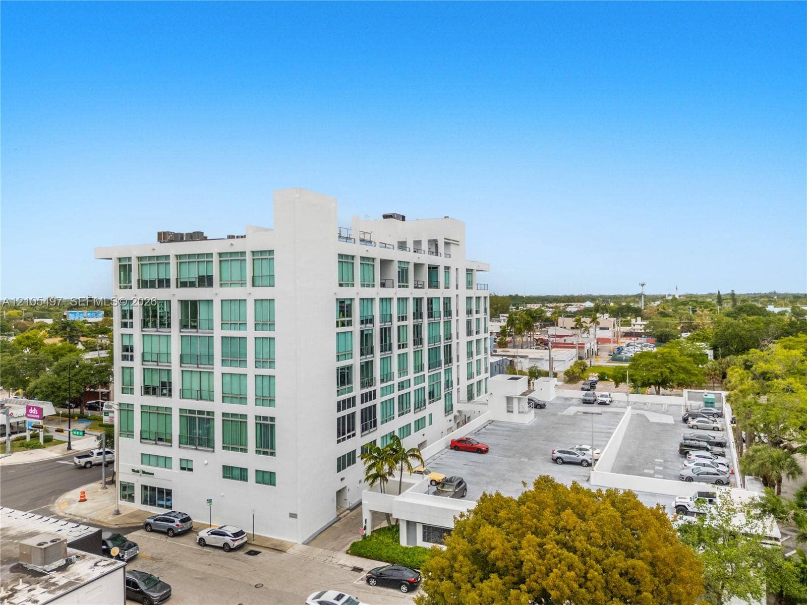 Modern multi-story building featuring expansive window lines and a white exterior