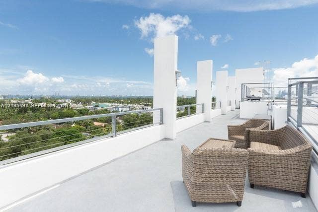 Expansive rooftop terrace with a light-colored surface and a cable railing system