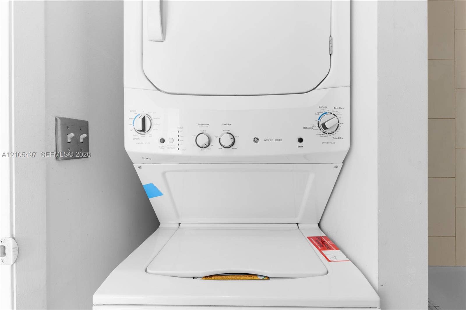Stacked washer and dryer unit