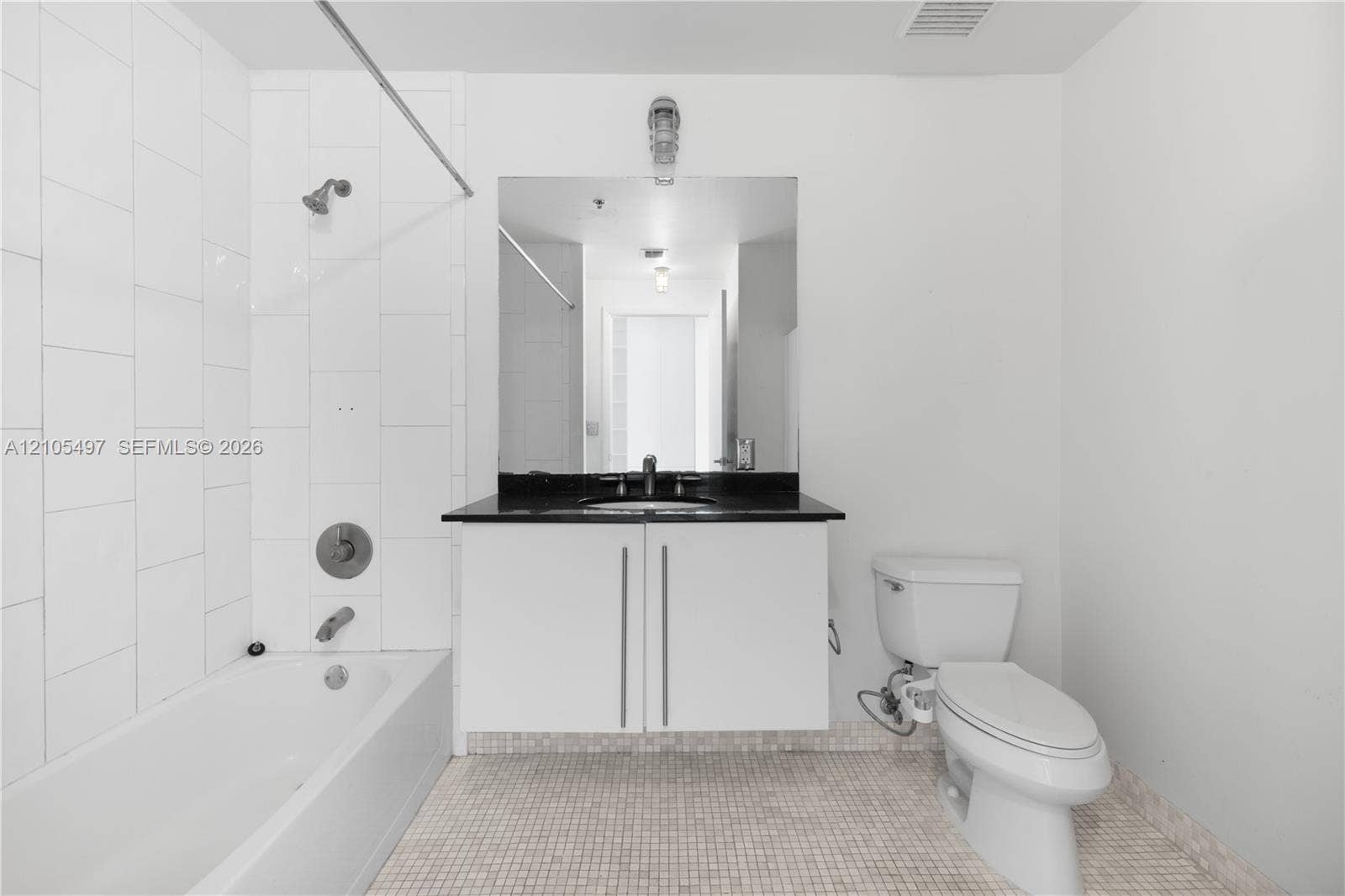 White subway-tiled shower surround with a built-in bathtub