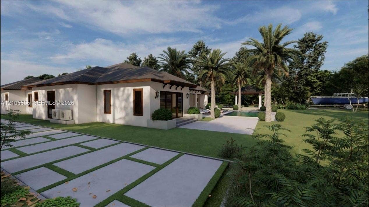 White stucco exterior with dark trim accents, concrete paver driveway, expansive green lawn, mature palm trees, and a swimming pool with a surrounding patio