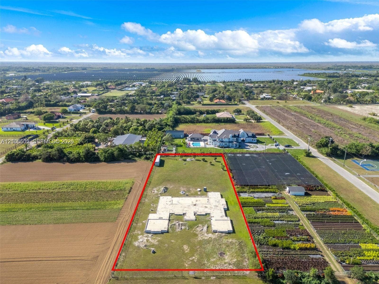 Expansive lot featuring a partial concrete foundation and surrounding open land