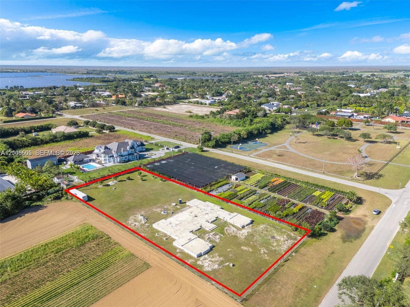 Expansive lot featuring a prepared building pad and surrounding green space
