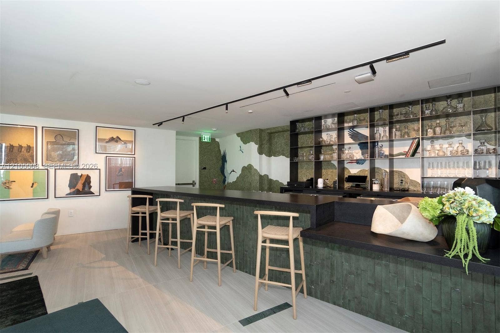 Bar area featuring a dark countertop, integrated shelving with glass accents, and wood-finish flooring