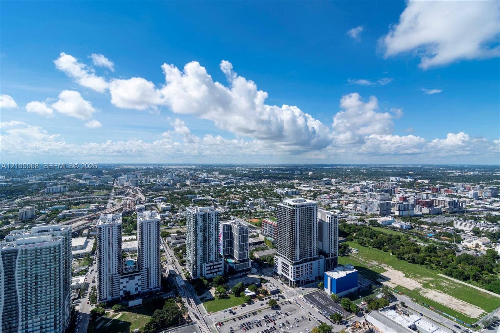 Expansive city panorama featuring multiple high-rise buildings and a broad urban landscape