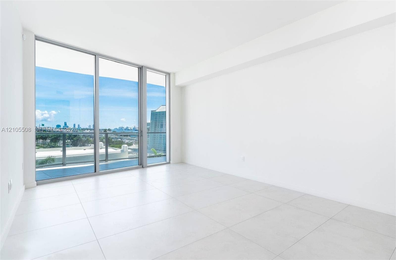 Expansive floor-to-ceiling glass doors with direct balcony access