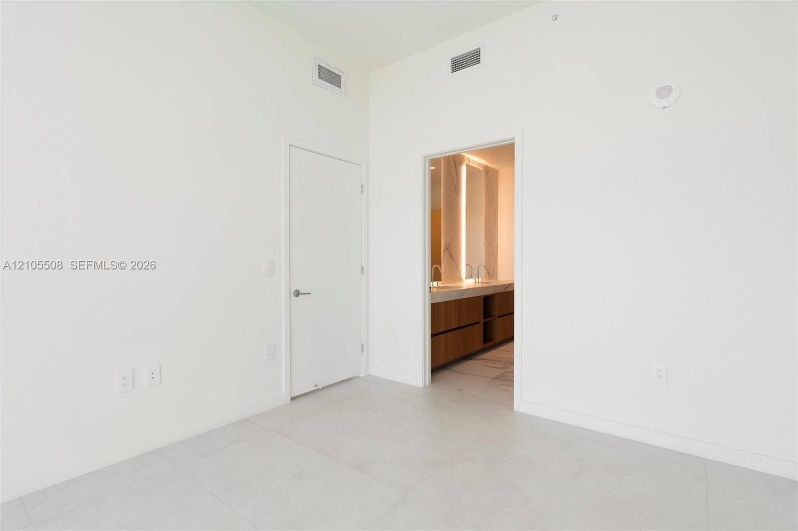 Tile flooring, recessed lighting, and a neutral color palette