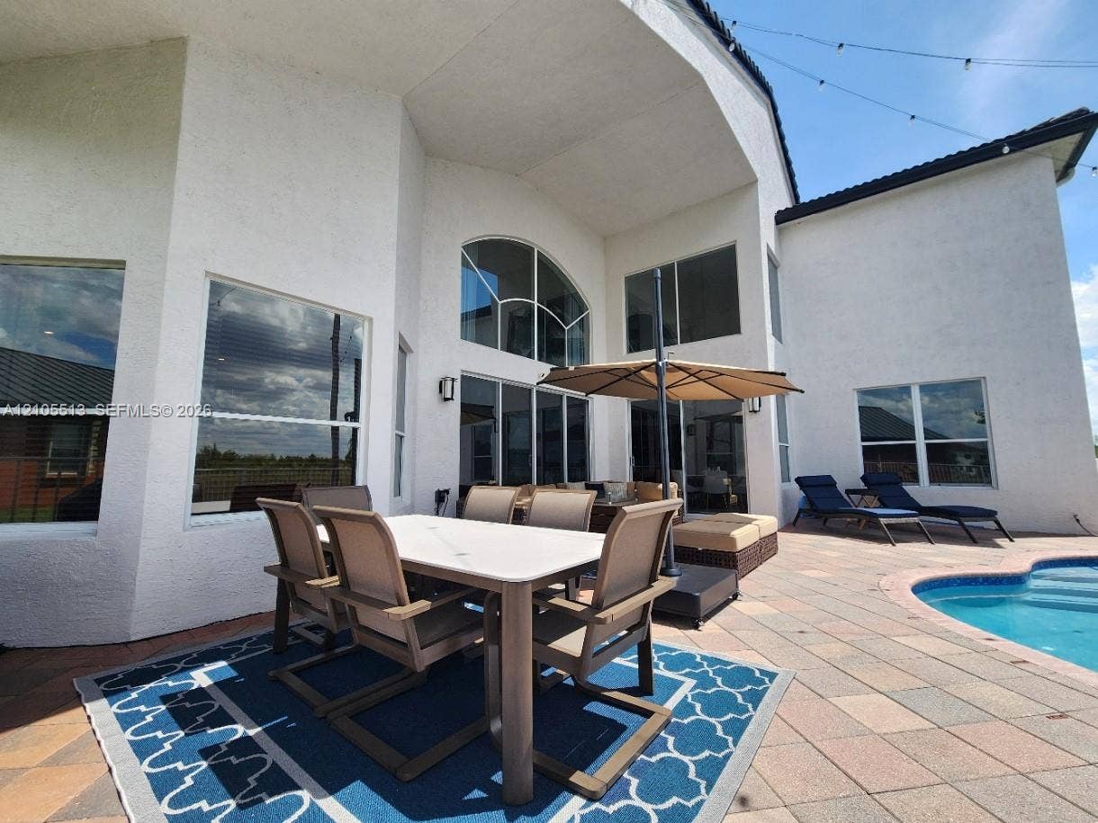 Expansive outdoor living area with plenty of room for seating, dining, lounging & grilling