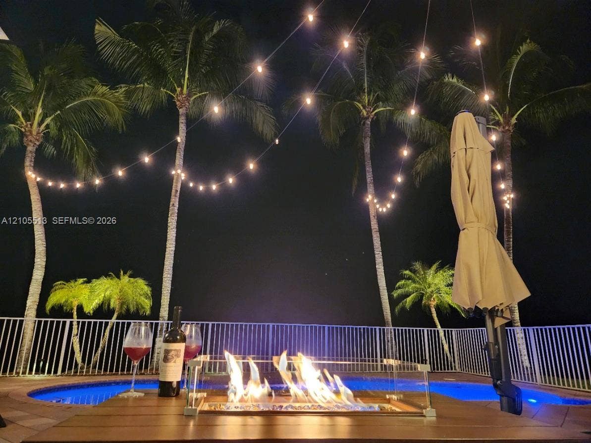 Night view of rear with automated multi-colored LED pool light & low voltage string lighting