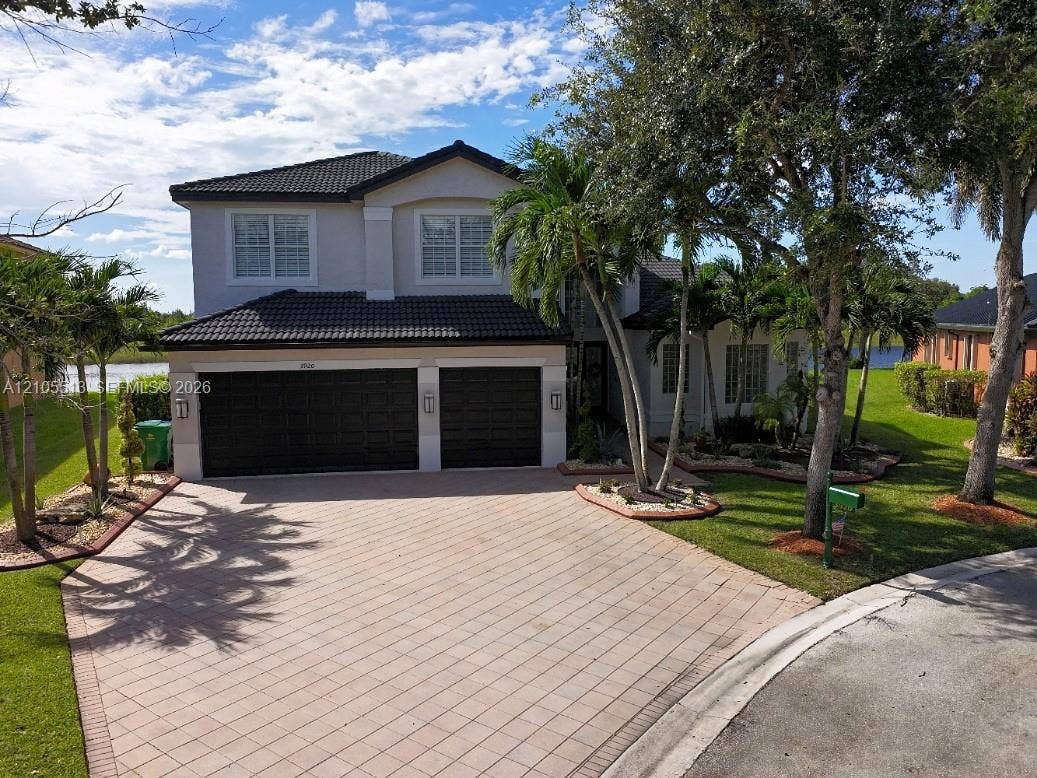 Two-story residence featuring a tile roof and a 3-car garage w/driveway parking for 6 cars