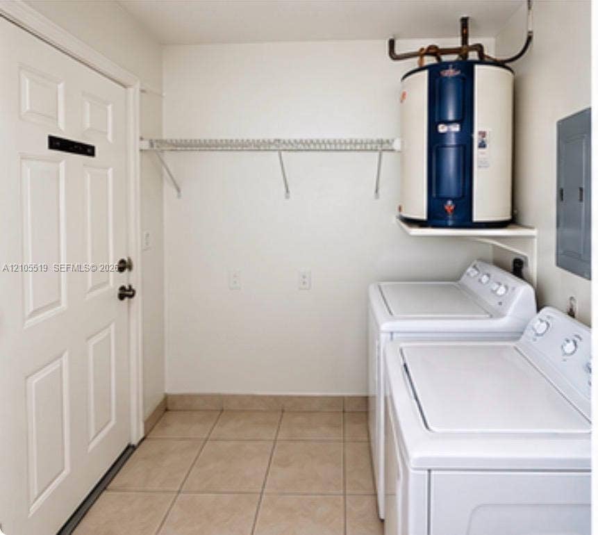 Laundry area featuring tile flooring, a utility door, and wall-mounted shelving