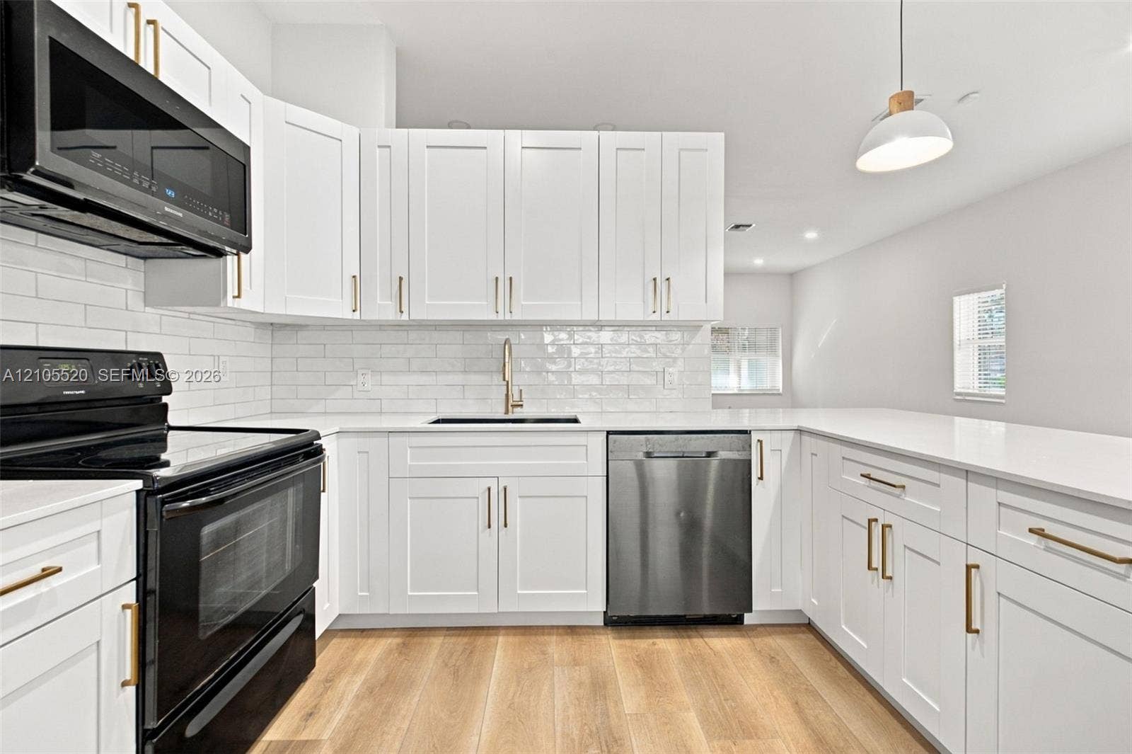649 Willow Bend Road, Weston, Weston, FL 33327 Kitchen featuring white shaker cabinetry, quartz countertops, subway tile backsplash, stainless steel appliances, and wood-finish flooring