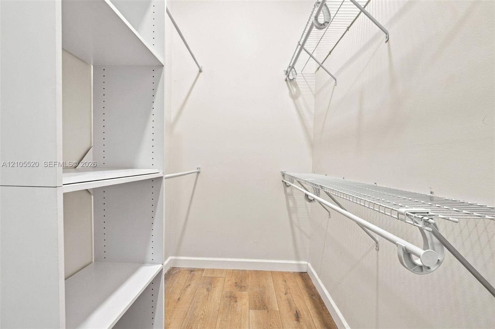 649 Willow Bend Road, Weston, Weston, FL 33327 Walk-in storage space featuring wood-finish flooring, white laminate shelving towers, and white wire rack shelving with integrated hanging rods