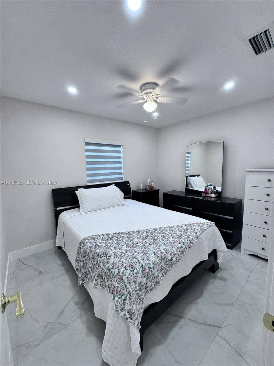 Recessed lighting, ceiling fan, window with horizontal blinds, and large format tile flooring