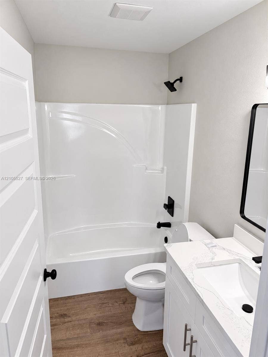White single-piece shower and tub combination with matte black fixtures
