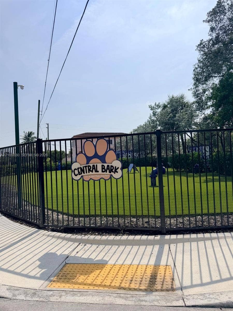 Fenced recreational area featuring artificial turf