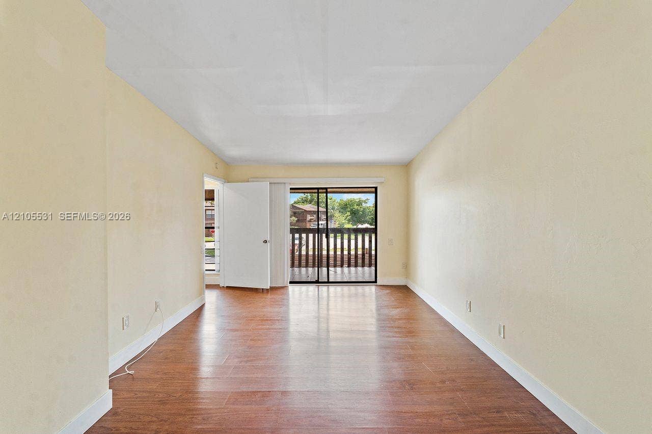 Wood-finish flooring throughout, complemented by light-toned wall finishes and white trim