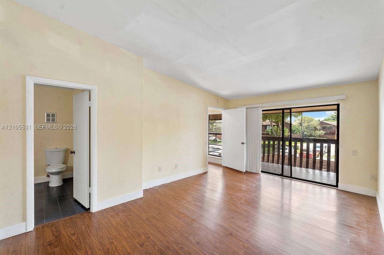 Wood-finish flooring throughout, complemented by light-colored walls