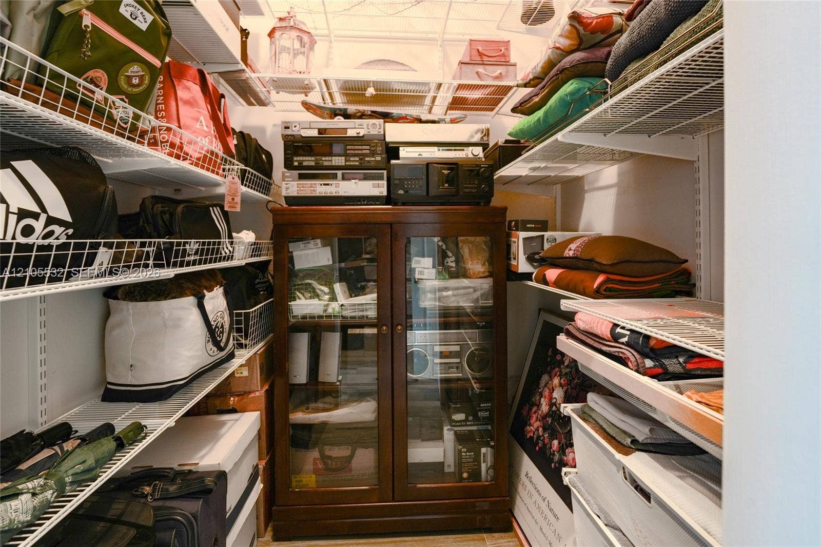 Walk-in closet featuring multi-level white wire shelving
