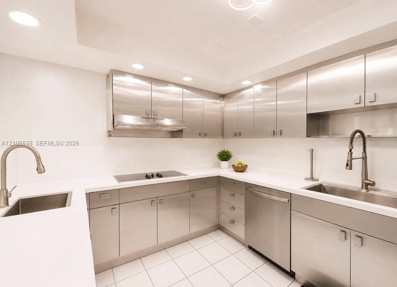 Modern kitchen featuring stainless steel cabinetry, white countertops, recessed lighting, and integrated stainless steel appliances