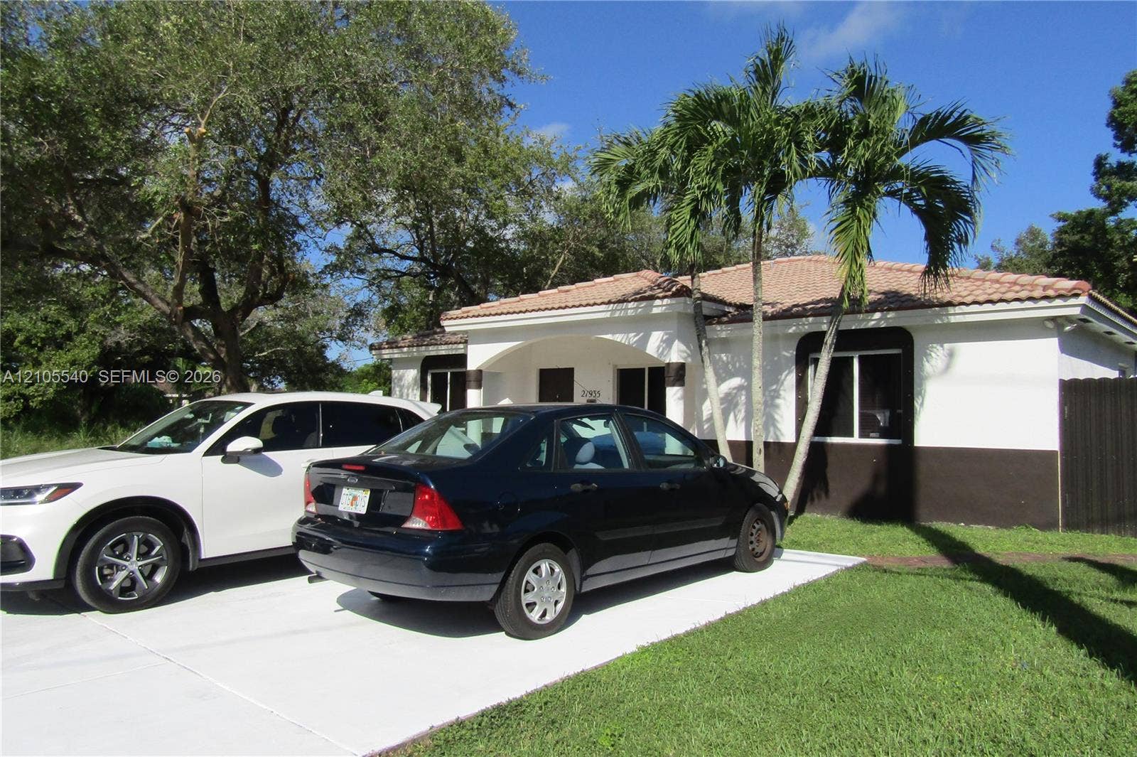 21935 SW 102nd Avenue, Cutler Bay, FL 33190 Single-story residence featuring a tile roof and a two-tone exterior