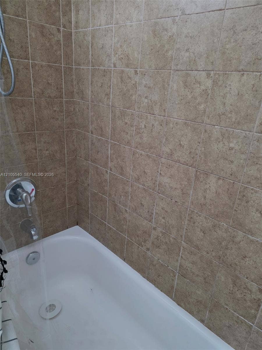 21935 SW 102nd Avenue, Cutler Bay, FL 33190 White bathtub with chrome fixtures and tiled surround